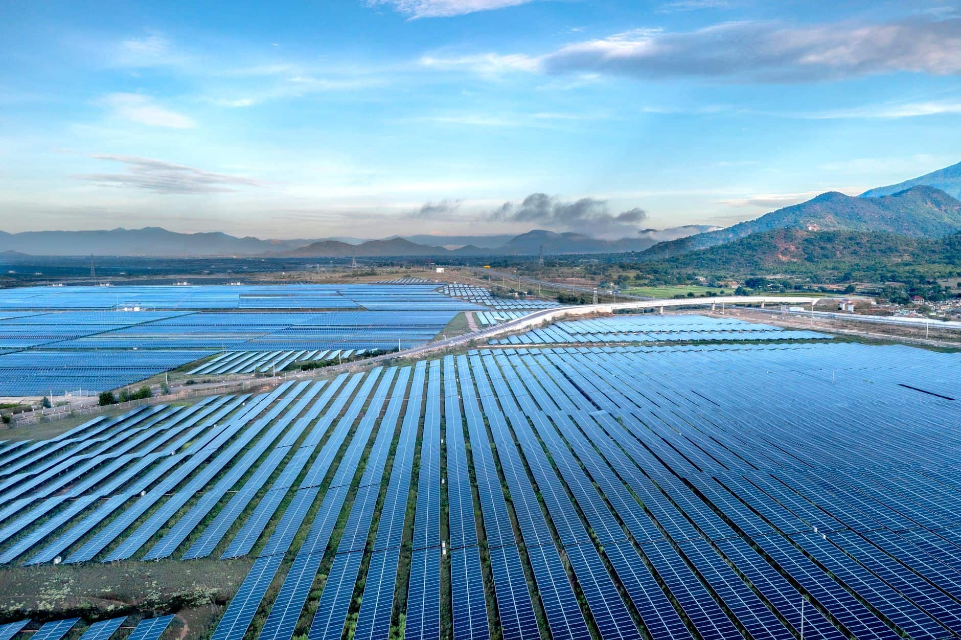 Aerial view of a sprawling solar farm under a vibrant sky in Vietnam's Ninh Thuan during daytime