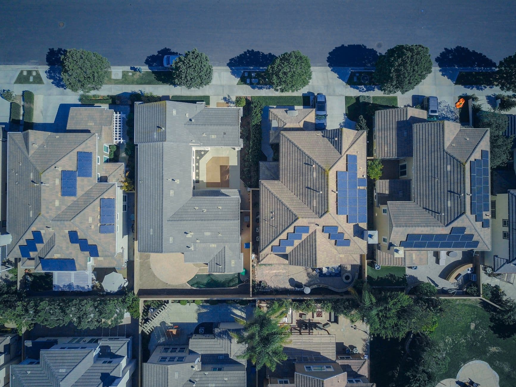 Aerial view of urban houses with solar panels on rooftops