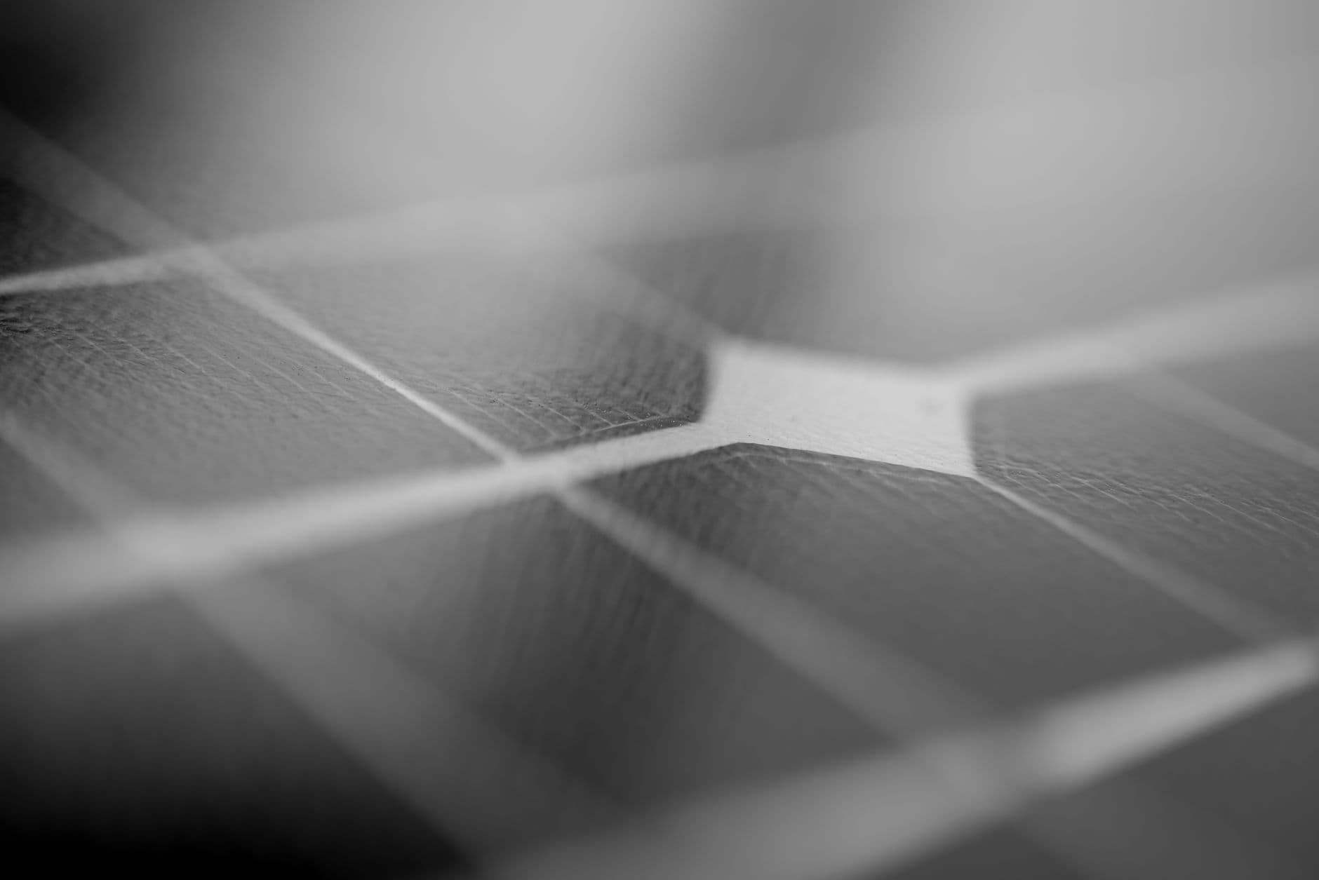Close-up of a solar panel surface showing texture and grid pattern