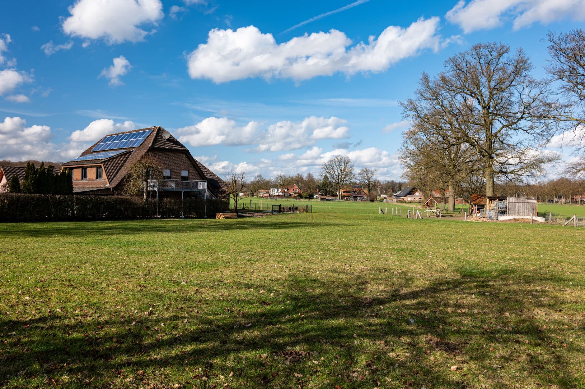 Solar panels on the roof of a house in Coesfeld, Germany, set against a scenic rural landscape