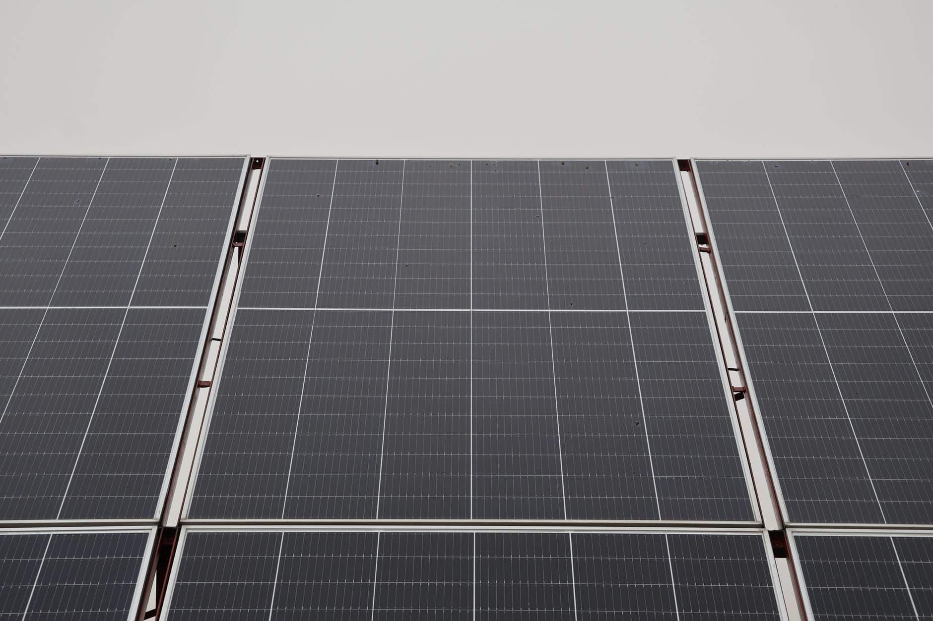 Close-up view of modern solar panels under an overcast sky