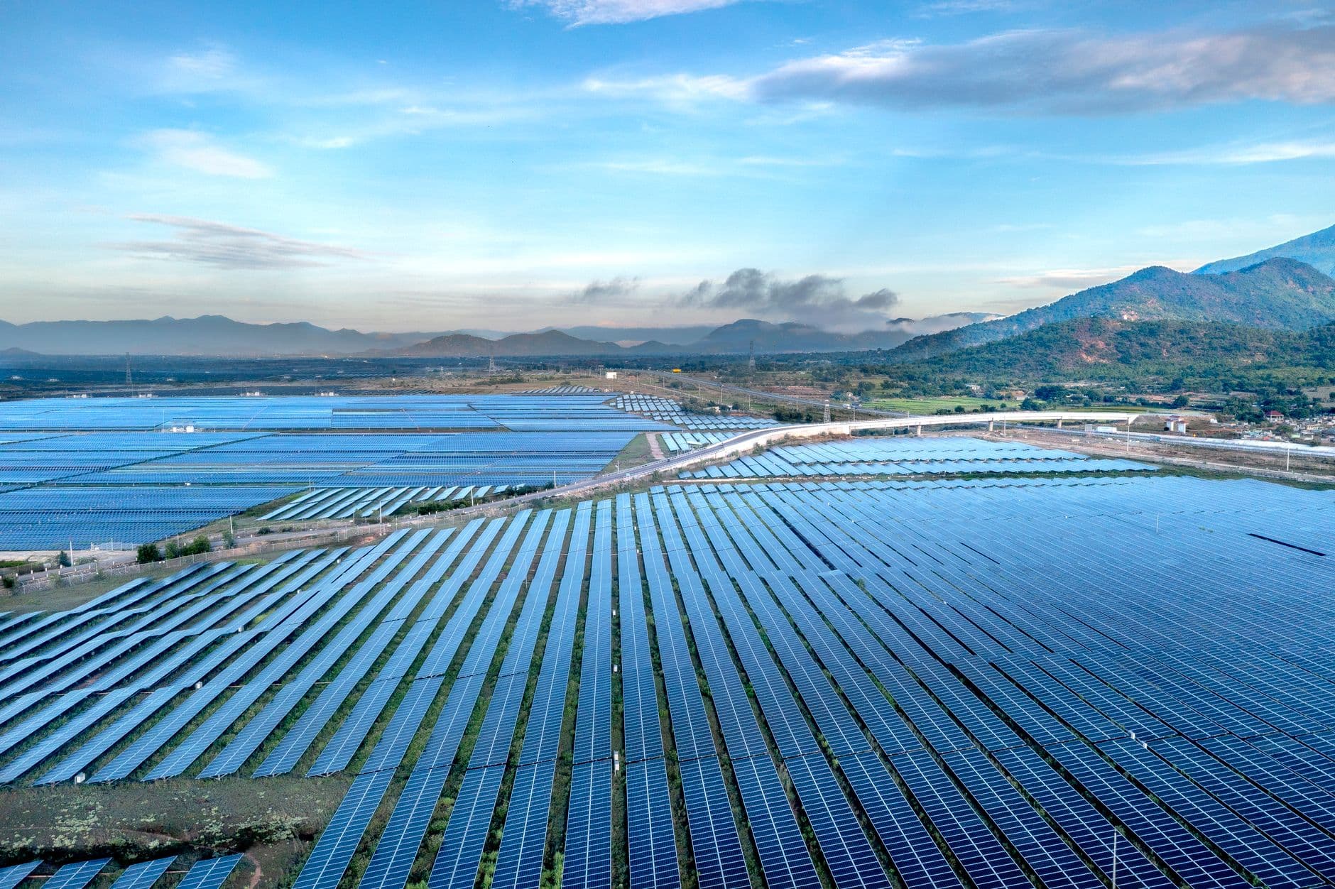 Aerial view of a sprawling solar farm under a vibrant sky in Vietnam's Ninh Thuan during daytime