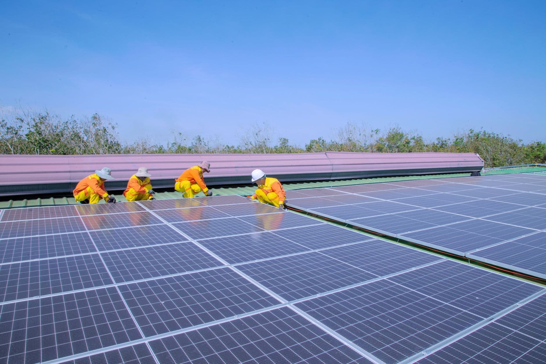 Workers installing solar panels on a sunny day