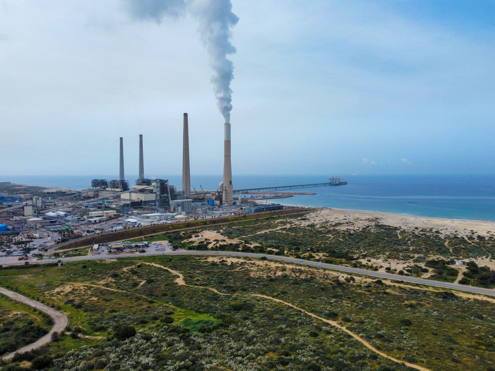 Aerial view of the Hadera power plant with smokestacks near the Mediterranean Sea in Israel