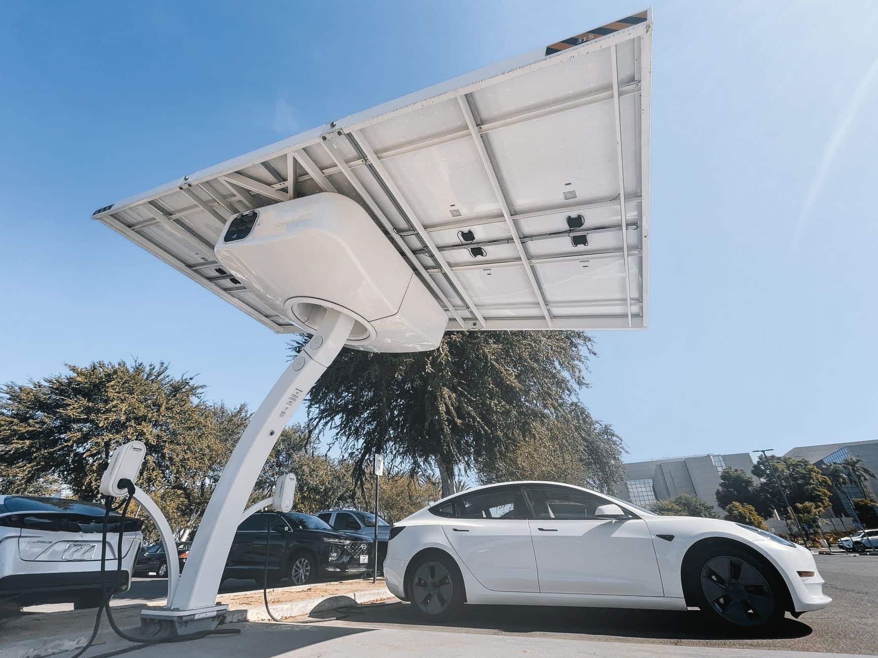 Electric car charging at a solar panel canopy