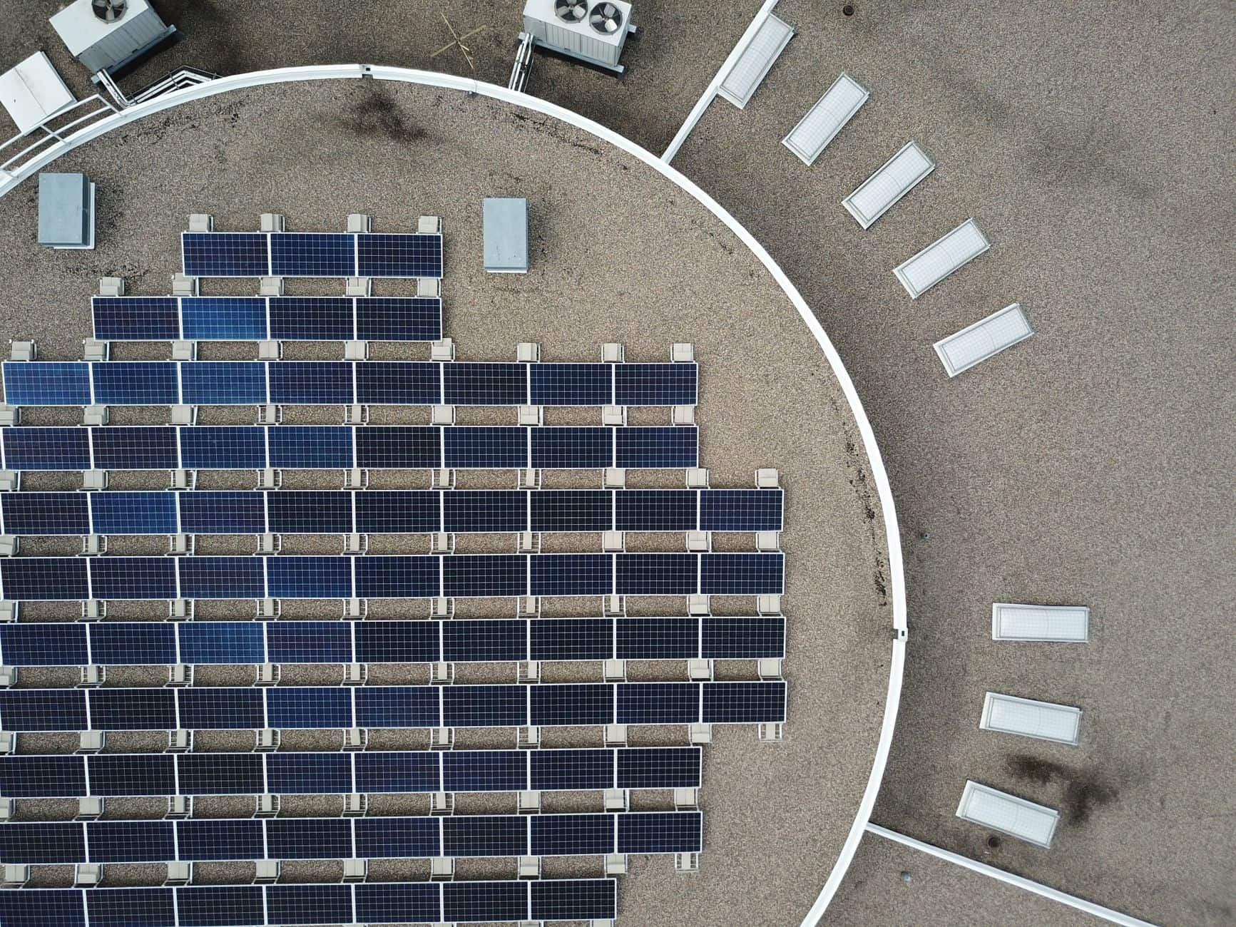 Aerial view of solar panels installed on an urban rooftop
