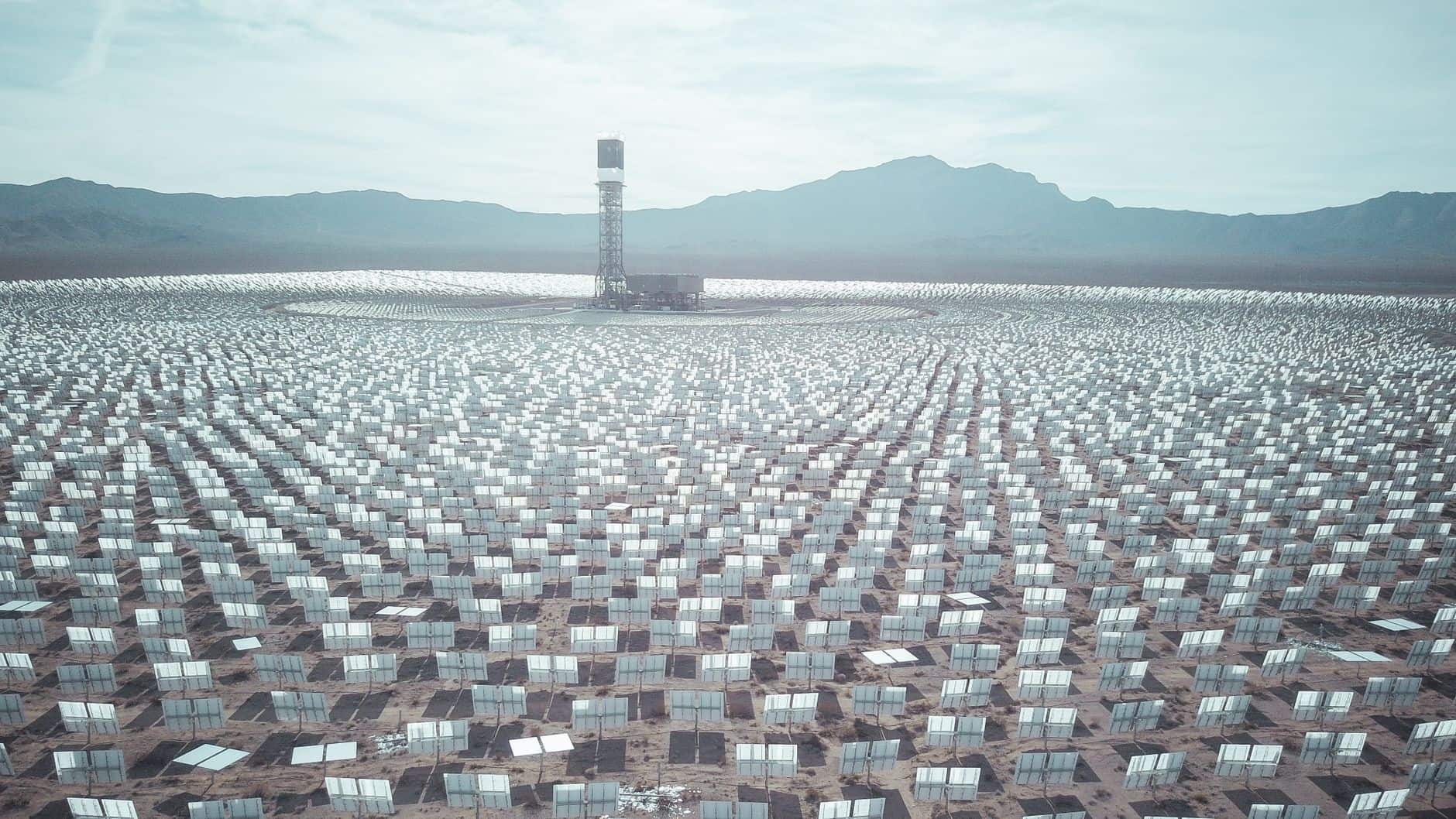 Aerial view of a large solar farm stretching across a desert landscape