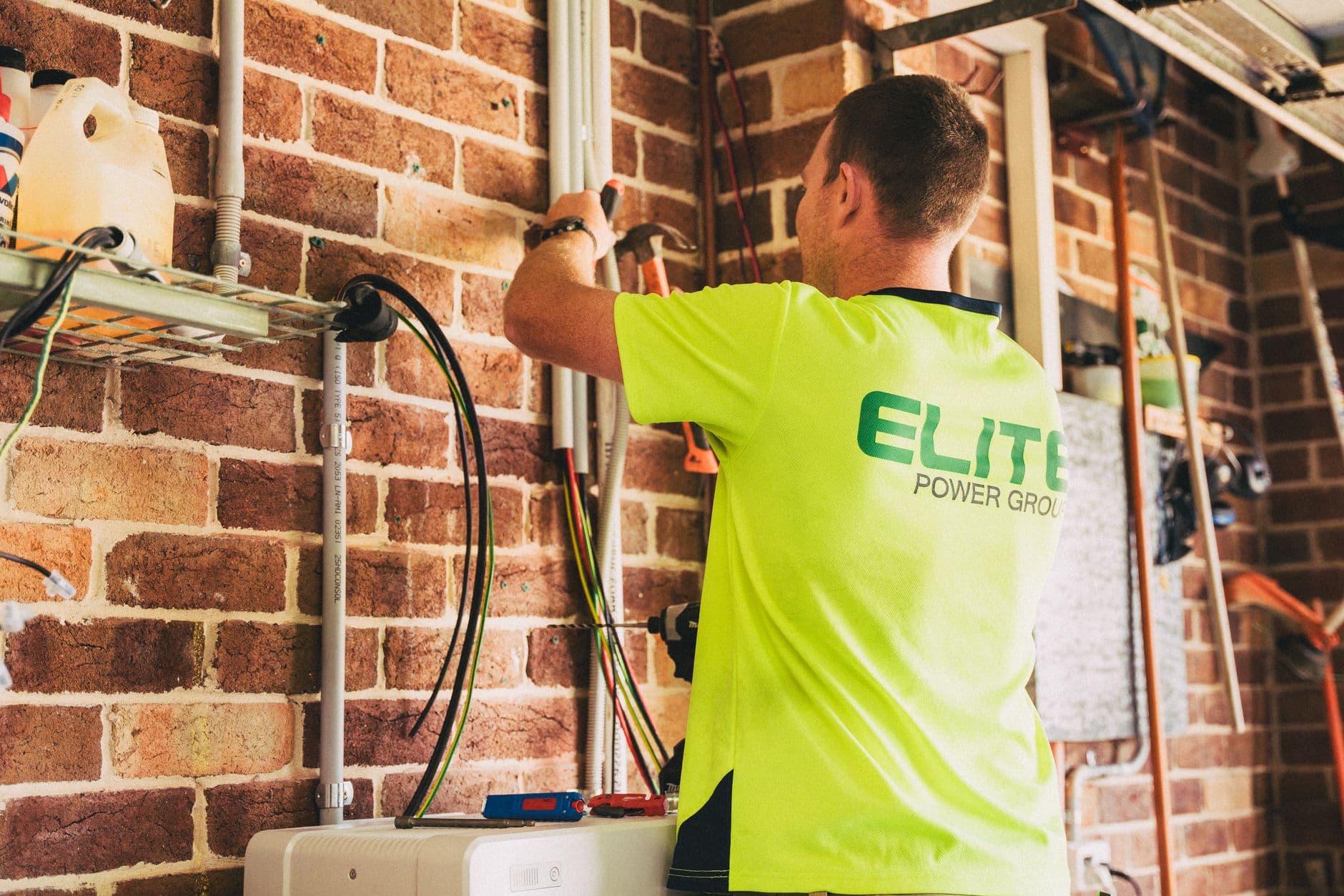 Electrician installing a solar battery system in a home