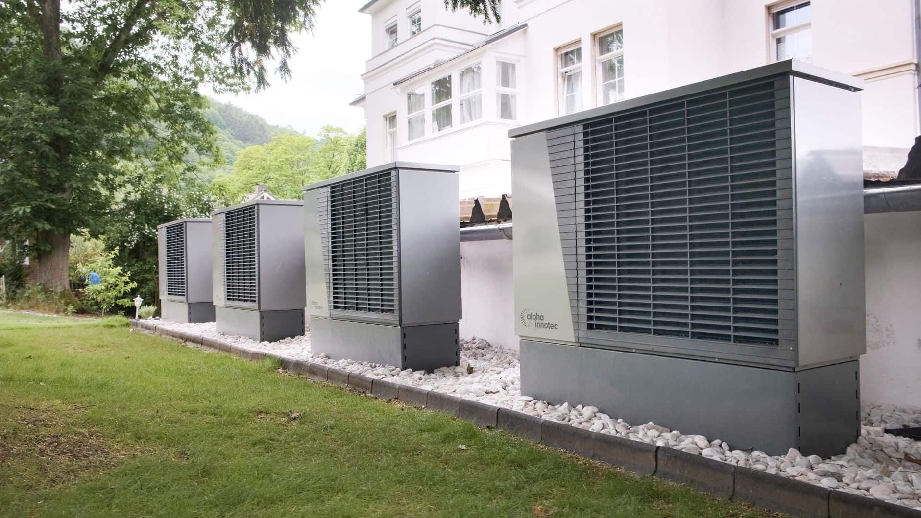 Row of commercial heat pump units installed outside a building