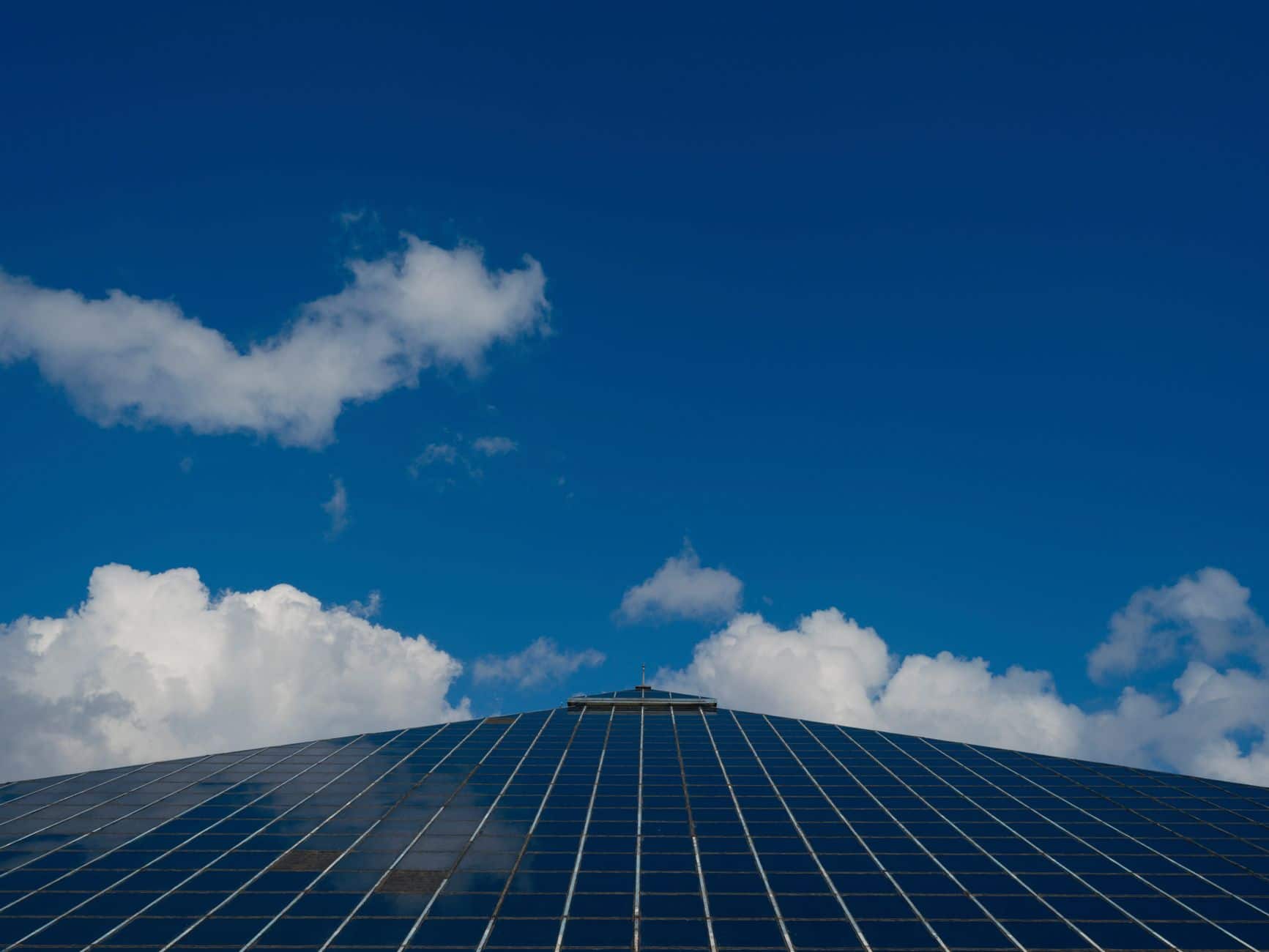 Solar panels reflecting a clear blue sky