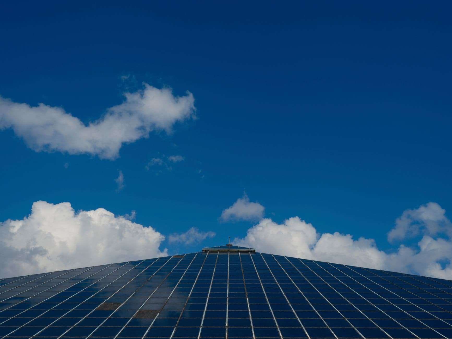 Solar panels reflecting a clear blue sky