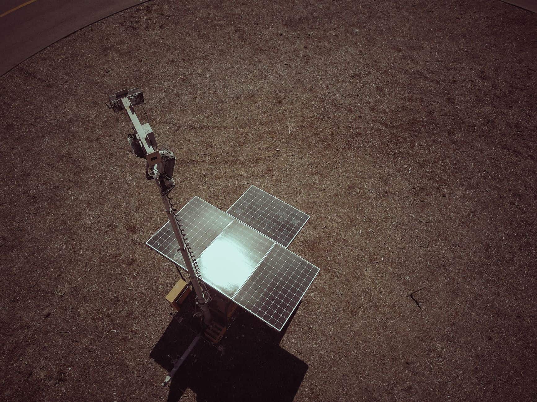 Aerial view of solar panels on a dry, barren landscape