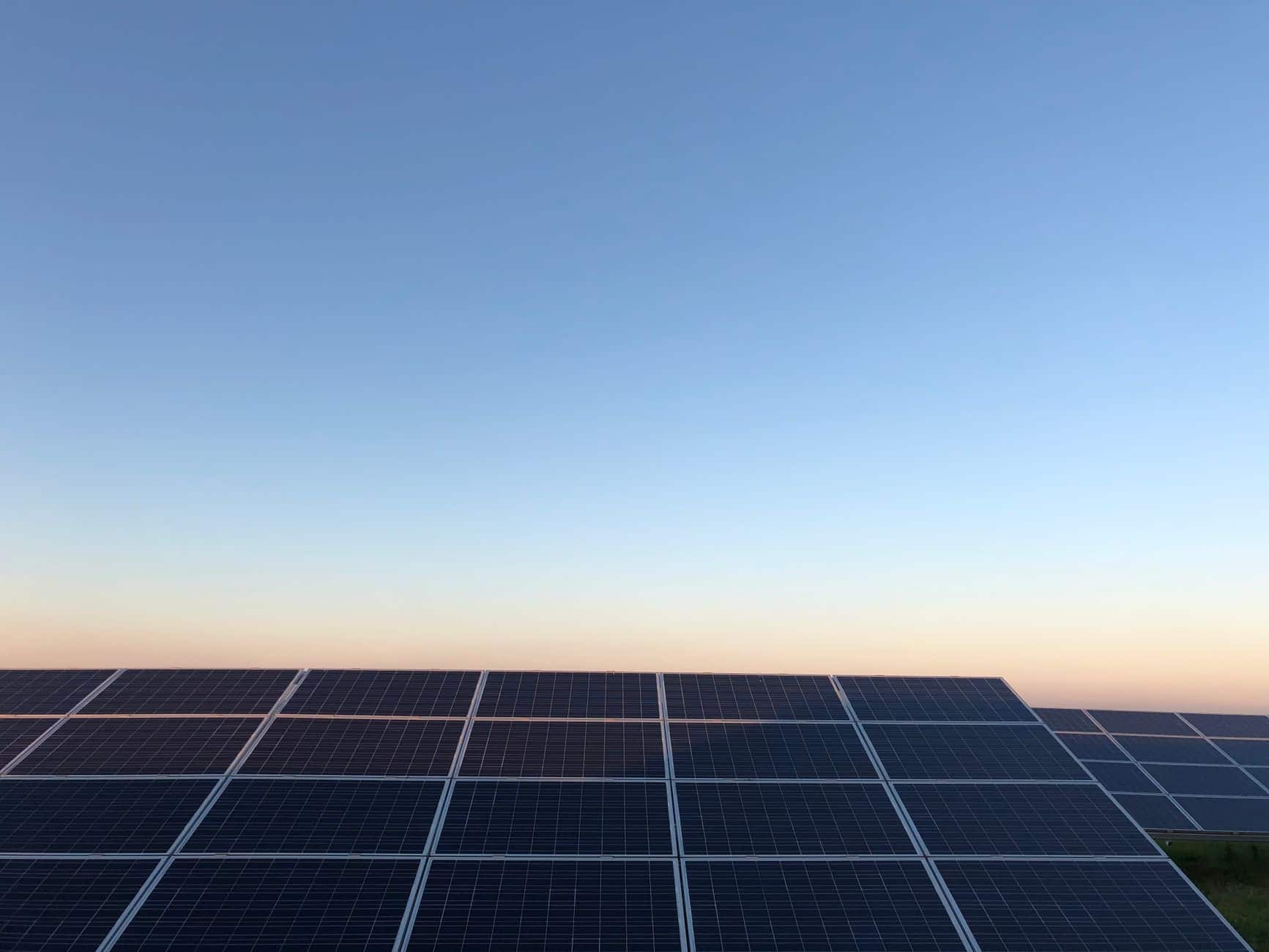 Solar panels on a field near Andria, Italy at sunrise