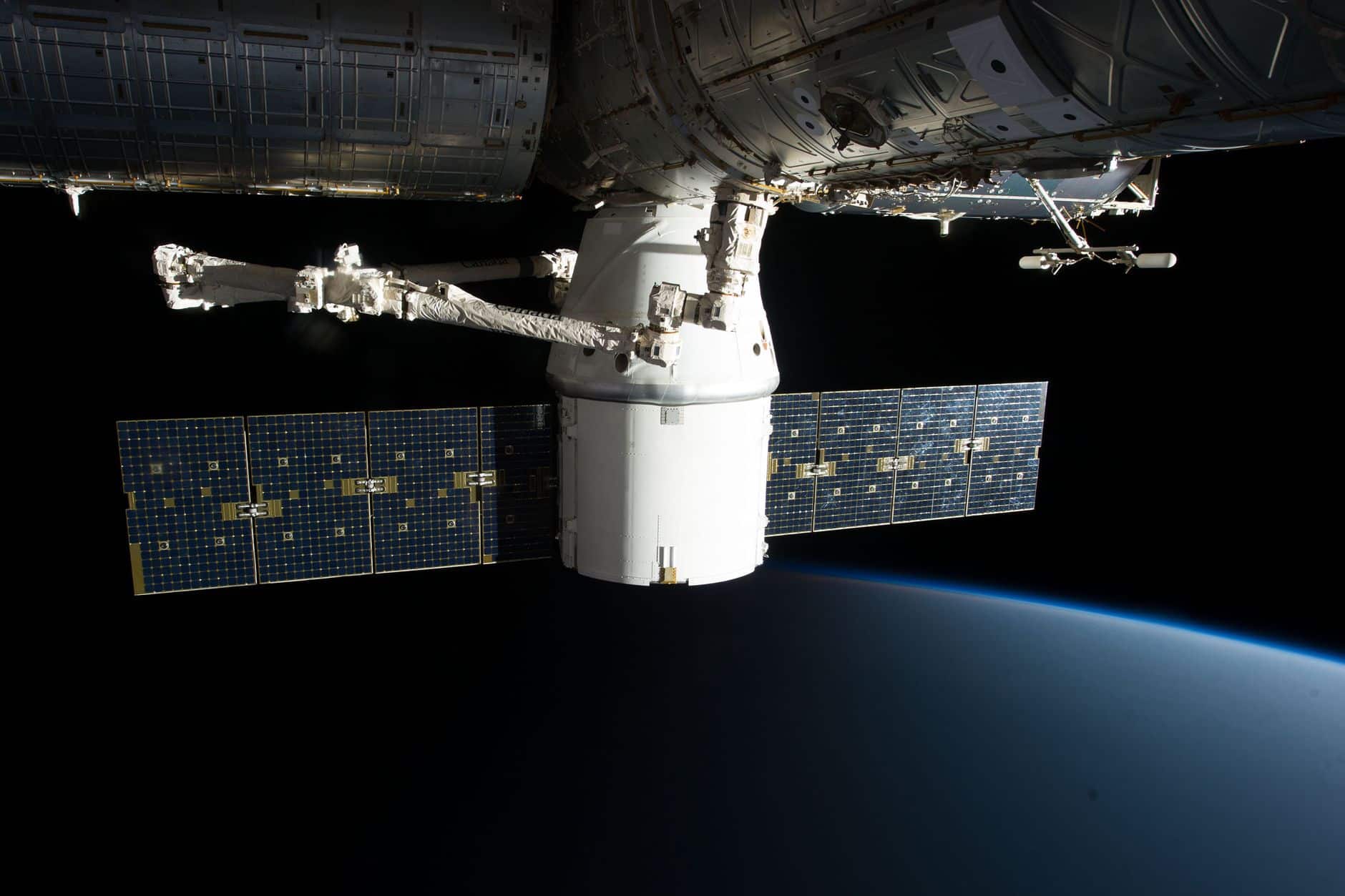 International Space Station with large solar arrays orbiting Earth
