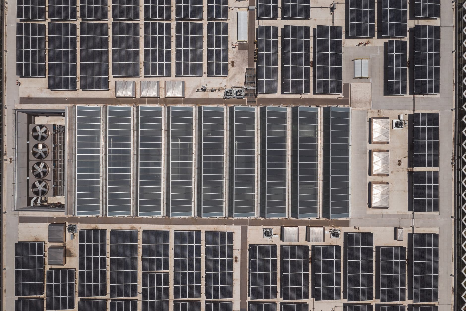 High‑angle drone view of rooftop solar panels illustrating renewable energy technology