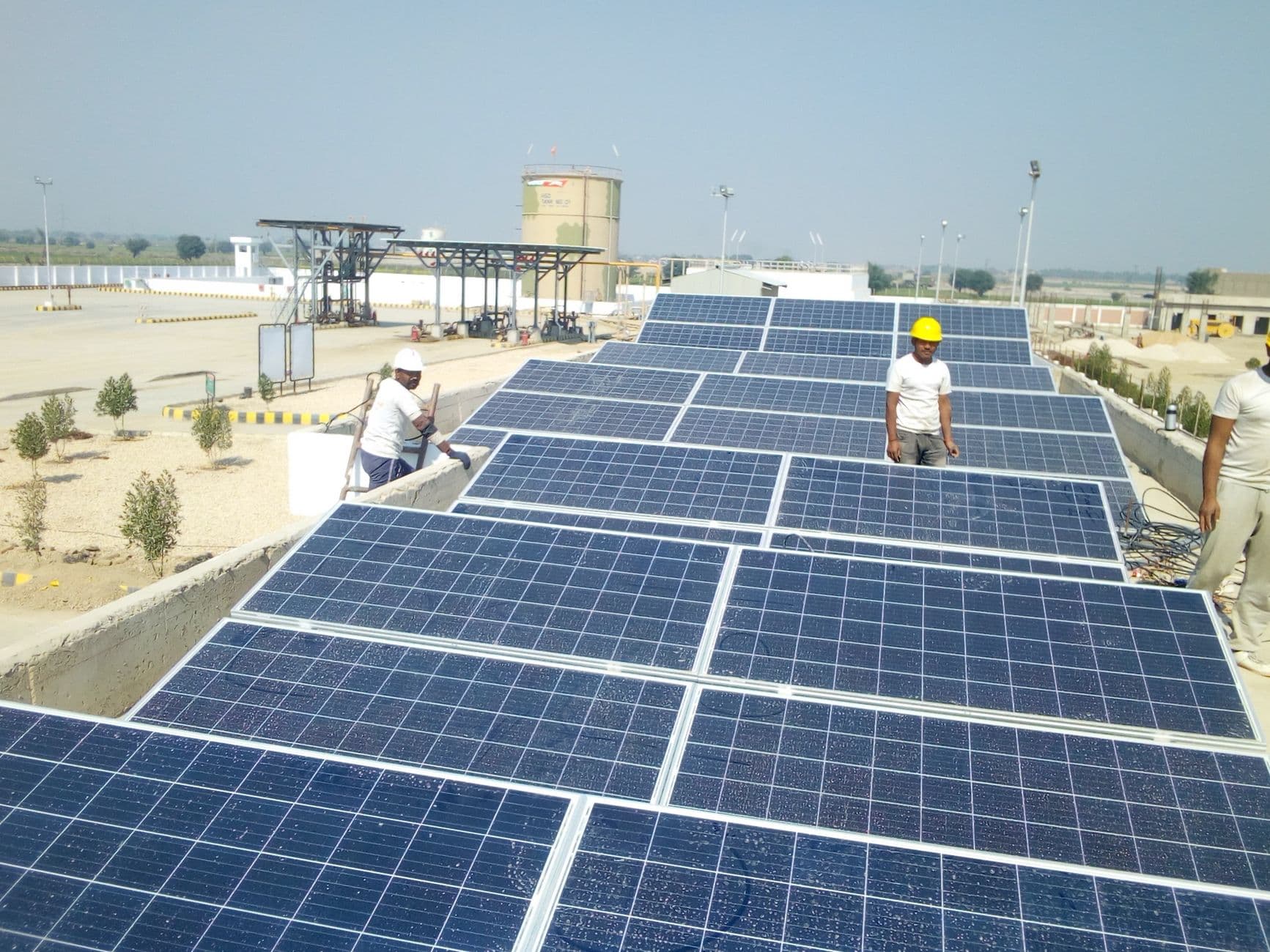 Workers installing solar panels on a rooftop for renewable energy generation